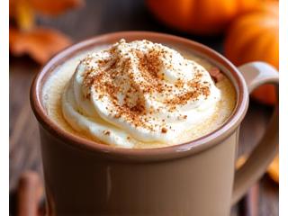 Spiced pumpkin latte with whipped cream and cinnamon stick.