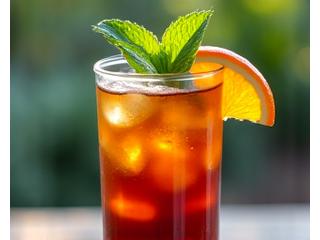Refreshing cold brew coffee cocktail with orange slices and mint.