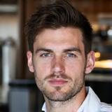 Professional headshot of Liam, Head Barista, confidently smiling